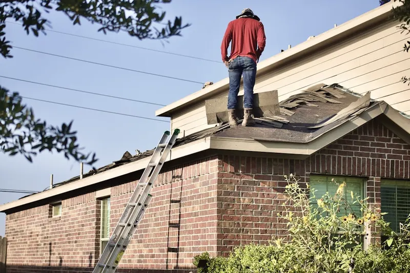 Professional roofer working on a residential roof in Red Mountain